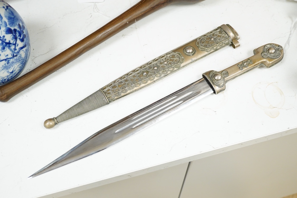 An African hardwood throwing club together with a painted mask and a Caucasian style dagger kindjal, largest 34cm high